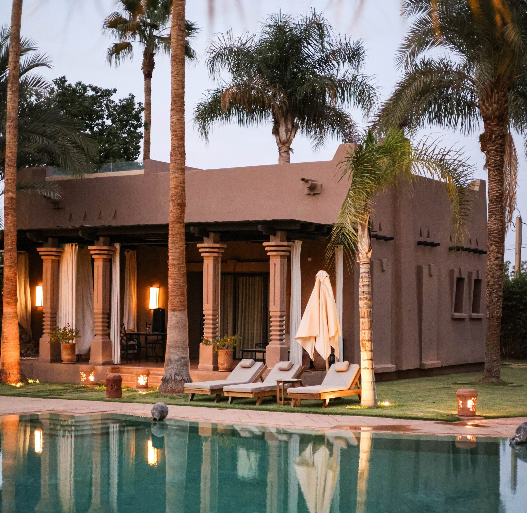 Private villa with illuminated pool at dusk near Marrakech