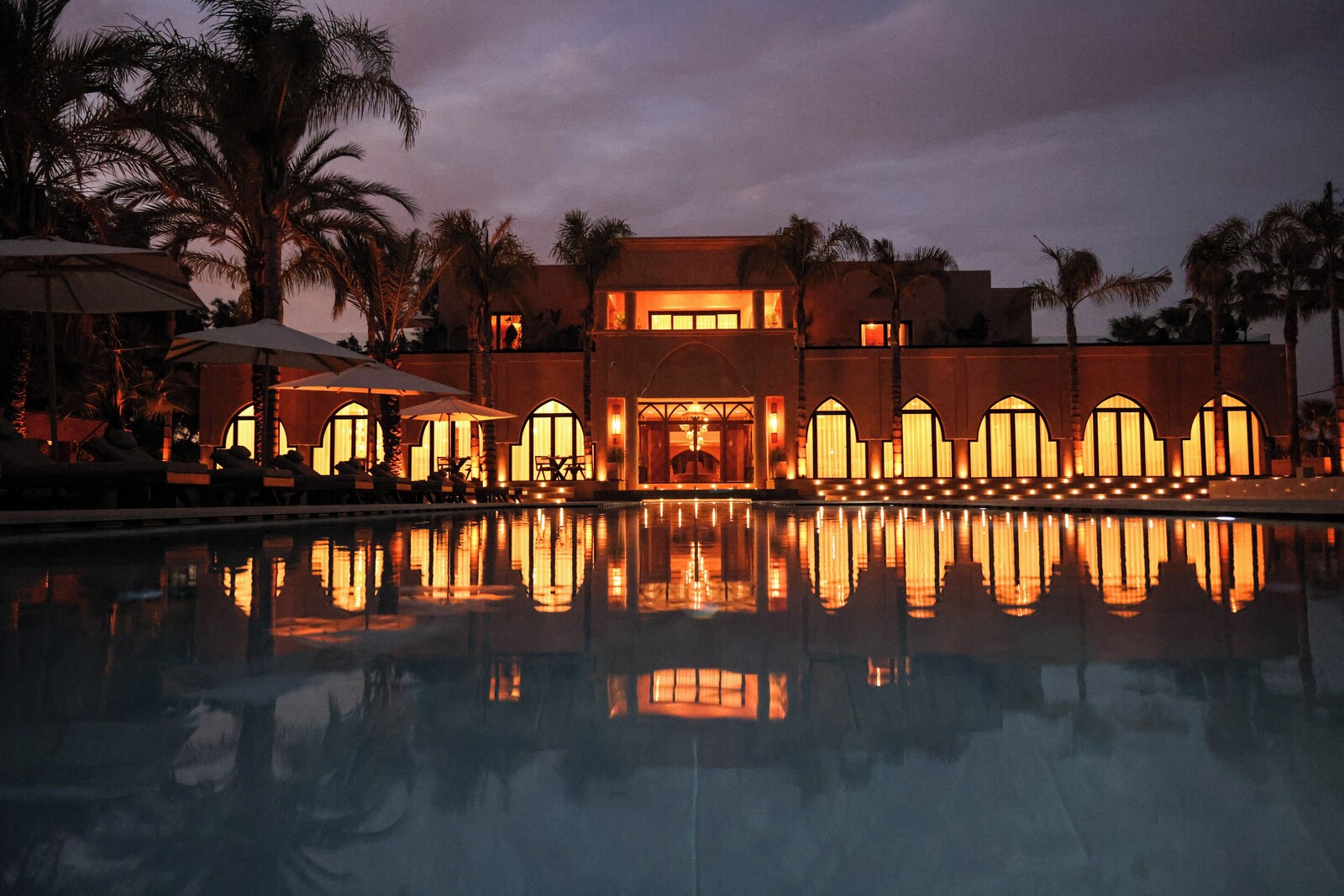 Estate reflected in the pool at nightfall near Marrakech